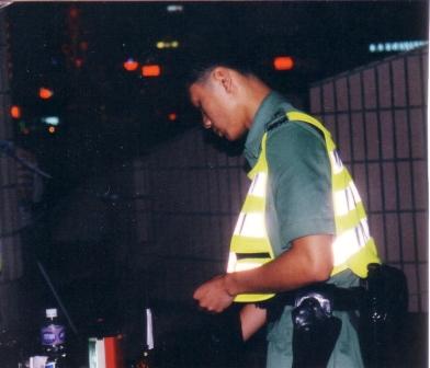 police changing insignia at mid night of hong kong handover
